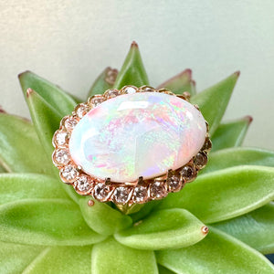 Pre-loved Oval Opal Ring With a Diamond Halo Set in 14ct Yellow Gold